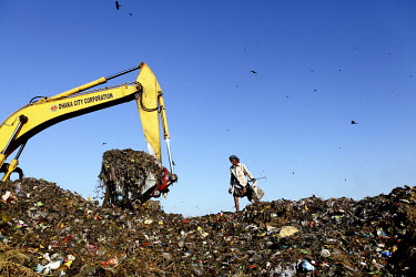 A man looks for recyclable material at the biggest rubbish dump in Dhaka. The city alone generates about 3500 to 4000 metric tons of solid waste each day.