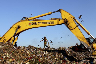 A young man looks for recyclable material at the biggest rubbish dump in Dhaka. The city alone generates about 3500 to 4000 metric tons of solid waste each day.