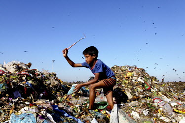 A boy looks for recyclable material at the biggest rubbish dump in Dhaka. The city alone generates about 3500 to 4000 metric tons of solid waste each day.
