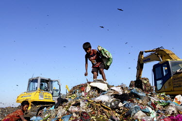 Children look for recyclable material at the biggest rubbish dump in Dhaka. The city alone generates about 3500 to 4000 metric tons of solid waste each day.