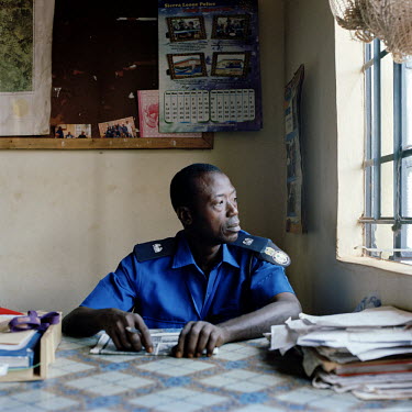 Usman Sahr Amara, operations director, sits at his desk at the central police station in Makeni.