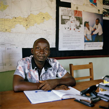 Paralegal Daniel Moseray Fullah, sits at his desk in an NGO's offices.