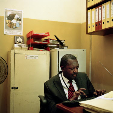 The director of the Anti-Corruption Commission's Report Centre, where members of the public can lodge complaints, report abuses or suspicions, at work in his office logging records on a computer.