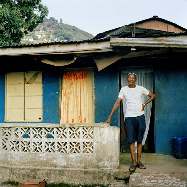 The Imam of Kissy Brook in the east end of Freetown, stands outside his home.
