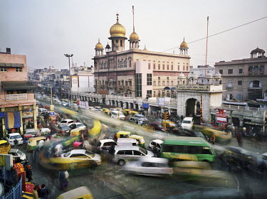 A view of Chandni Chowk Street in Old Delhi with traffic and crowds of people.