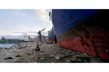 A man removes diesel from a beached ship near Tacloban city after Typhoon Haiyan swept through the Philippines. Typhoon Haiyan, or Yolanda as it is known in the Philippines, made landfall on 8 Novembe...
