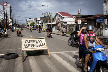 A sign indicts the hours of a curfew in Tacloban after Typhoon Haiyan swept through the Philippines. Typhoon Haiyan, or Yolanda as it is known in the Philippines, made landfall on 8 November 2013 and...