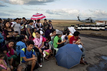 People displaced by Typhoon Haiyan wait, at Tacloban airport,  to get on a US military flight to Manila. Typhoon Haiyan, or Yolanda as it is known in the Philippines, made landfall on 8 November 2013...