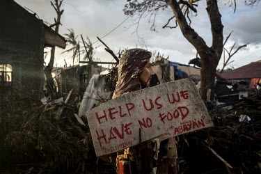A sign attached to a statue of Jesus, standing among the devastation left by Typhoon Haiyan, reads: 'Help us we have no food'. Typhoon Haiyan, or Yolanda as it is known in the Philippines, made landfa...