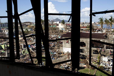 A scene of mass devastation, seen through the battered remains of a set of windows, in Tacloban city after Typhoon Haiyan swept through the Philippines. Typhoon Haiyan, or Yolanda as it is known in th...