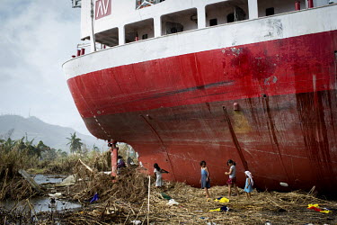 Children scavenge items from a ship left sitting in a field near Tacloban city after Typhoon Haiyan swept through the Philippines. Typhoon Haiyan, or Yolanda as it is known in the Philippines, made la...
