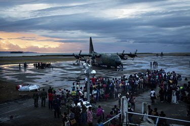 People displaced by Typhoon Haiyan wait, at Tacloban Airport,  to get on a military flight to Manila. Typhoon Haiyan, or Yolanda as it is known in the Philippines, made landfall on 8 November 2013 and...