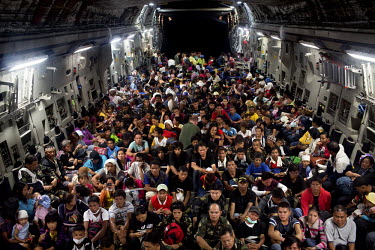 Over 400 people, displaced by Typhoon Haiyan in Tacloban, squeeze onto a C-17 US Air Force military transport aircraft bound for Manila. Typhoon Haiyan, or Yolanda as it is known in the Philippines, m...