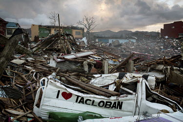 A vehicle, decorated with 'I love Tacloban', sits, crushed, beneath the debris and destruction left by Typhoon Haiyan. Typhoon Haiyan, or Yolanda as it is known in the Philippines, made landfall on 8...