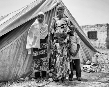 A woman and her three children outside the tent that is their home in Kharaz refugee camp. The camp holds roughly 15,000 mainly Somali migrants, half of whom are children. The United Nations Refugee A...