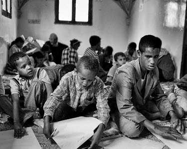 Children writing on sheets of paper at a school catering for migrants, most of whom are from Somalia. The United Nations Refugee Agency (UNHCR) has raised concerns over the record numbers of Ethiopian...