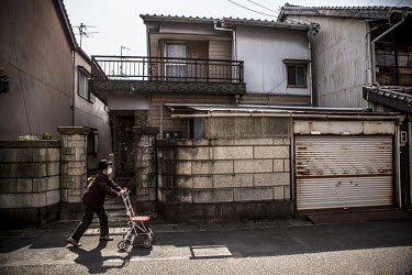 A neighbour passes the house where the murder of the Hashimoto family took place in 1966. The house was rebuilt after a fire and the eldest daughter still lives in the house. Iwao Hakamada (b. 1936) w...