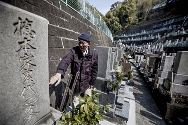 Tamio Umeda, from Shimizu Shizuoka citizens group who support Iwao Hakamada, points to the tombstone of the Hashimoto family whom Hakamada was accused of murdering in Ohirayama cemetery. Iwao Hakamada...