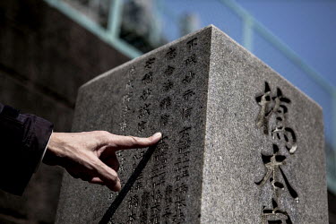 Tamio Umeda, from Shimizu Shizuoka citizens group who support Iwao Hakamada, points to the tombstone of the Hashimoto family whom Hakamada was accused of murdering in Ohirayama cemetery. Iwao Hakamada...
