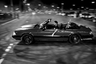 A man performs a 'donut' during a 7th Street Sideshow, an illegal gathering of car and motorbike enthusiasts who come together to perform stunts and hold street drag races. In the Bay Area, deep in Ea...