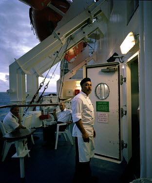 Crew members of the RMS St Helena take a break. There are only two remaining Royal Mail Ships, the other being Cunard's Queen Mary 2. The RMS St Helena is the only link to the outside world for the is...