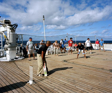 Passengers play cricket on the deck of the RMS St Helena. There are only two remaining Royal Mail Ships, the other being Cunard's Queen Mary 2. The RMS St Helena is the only link to the outside world...