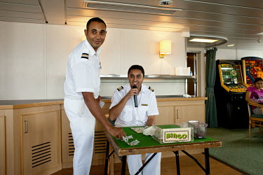 Assistant Purser Merrill Joshua and Purser Customer Care, Alan Bennett entertain guests onboard the RMS St Helena with a game of bingo. There are only two remaining Royal Mail Ships, the other being C...