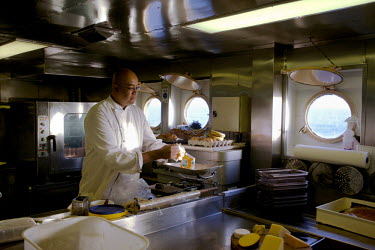 Chef Karl Schulz working in the galley of RMS St Helena. There are only two remaining Royal Mail Ships, the other being Cunard's Queen Mary 2. The RMS St Helena is the only link to the outside world f...