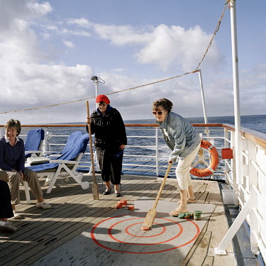 Passengers playing deck games on the RMS St Helena. There are only two remaining Royal Mail Ships, the other being Cunard's Queen Mary 2. The RMS St Helena is the only link to the outside world for th...
