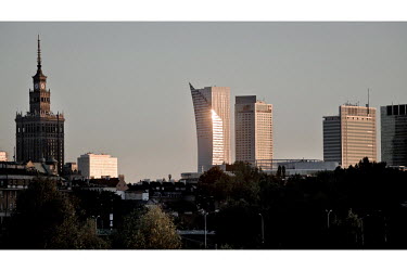 Warsaw city centre skyline, shot from Praga district on the far bank of the Vistula River. The setting sun is reflecting off Daniel Liebeskind's Zlota 44 building. The Palace of Culture and Science, a...