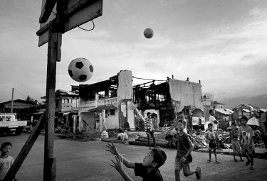 A group of boys playing basketball on a patch of ground cleared of debris following Typhoon Haiyan. Typhoon Haiyan, or Yolanda as it is known in the Philippines, made landfall on 8 November 2013 and w...
