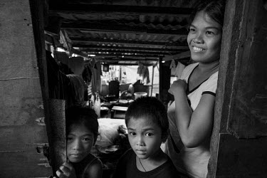 Manyanetta and her children in the makeshift shelter where their house once stood. She says: 'We are OK. We are alive and we are healthy.' Typhoon Haiyan, or Yolanda as it is known in the Philippines,...