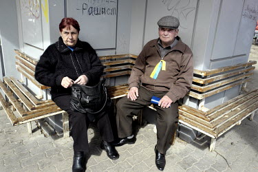 An elderly couple rest following a rally in support of Ukrainian unity held on the 40th day after the deaths of many protestors in clashes with security forces in Kiev. Events that led to the collapse...