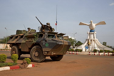 French peacekeepers aboard an armoured vehicle patrol past a statue of a 'dove of peace' on the airport road.In late 2012 after years of instability and conflict, the Seleka, a predominantly Muslim re...
