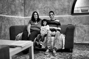 Maria del Mar Rodriguez (left) with her daughter Paula (center) and her husband Jonathan Martin at their home.  They were not able to pay their mortgage for the past 10 months, and recently they recei...