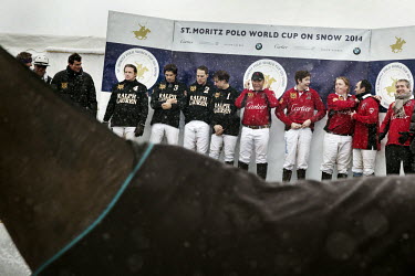 Team Ralph Lauren and Team Cartier riders on the podium for the the prize giving ceremony following the final, won by Team Cartier, of the 30th Polo on Snow World Cup. In the foreground is the horse L...