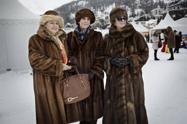 Draped in furs, spectators, Doris, Hanna and Myrtha from Switzerland, watch the 30th Polo on Snow World Cup as guests of sponsor BMW.