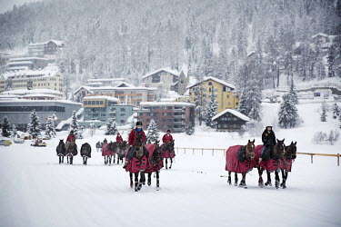 Horses competing in the 30th Polo on Snow World Cup are taken through the town to the frozen lake where the games are played.