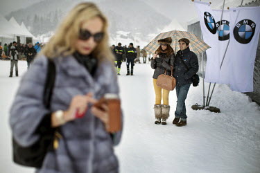 Spectators, dressed in furs, and busy on their mobile phones, at the 30th Polo on Snow World Cup.