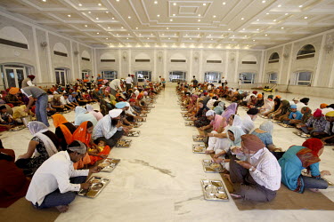 People share a communal meal in the Bangla Sahib Gurdwara.