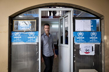 Khaled Hosseini, Goodwill Ambassador for UNHCR, stands in the doorway of the PARC (Protection Assistance Reintegration Center) office in Erbil. More than half of the 218,000 plus Syrians registered wi...