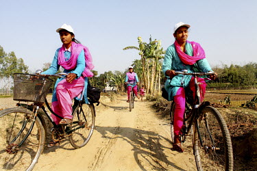 Info ladies riding along a rural road. In rural Bangladesh the Info Ladies are bringing internet services to men and women who need information but don’t have the means to access the web. After thre...