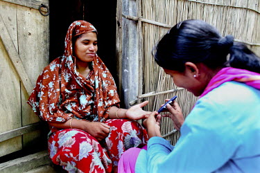 Info Lady Shathi gives a blood group test to a woman in a rural village. In rural Bangladesh the Info Ladies are bringing internet services to men and women who need information but don’t have the m...