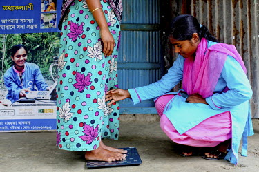 Info Lady Mahfuza weighs pregnant 18 year old Jahanara during her rounds. In rural Bangladesh the Info Ladies are bringing internet services to men and women who need information but don’t have the...
