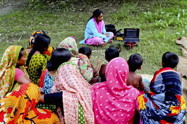 Info Lady Mahfuza talks to a group of women during a farmer's session during which she shows videos giving advice on various agricultural issues including rice harvesting. In rural Bangladesh the Info...