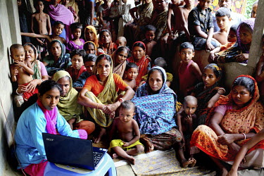 Info Lady Farhana talks to a group of women during a farmer's session during which she shows videos giving advice on various agricultural issues. In rural Bangladesh the Info Ladies are bringing inter...