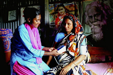 Info Lady Mahfuza measures the blood pressure of an client. In rural Bangladesh the Info Ladies are bringing internet services to men and women who need information but don't have the means to access...