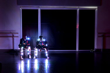 Dancers wearing light-suits take a break during the filming of Ghost Pelaton, which combines the athleticism of cycling and dance with cutting-edge lighting technology in Leeds. Phoenix Dance Theatre...