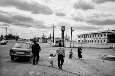 People walking in the town centre. During the 1950s and the 1960s the rivers that feed the Aral Sea (the Amu Darya and the Syr Darya) were diverted for irrigating cotton and other crops. This caused t...