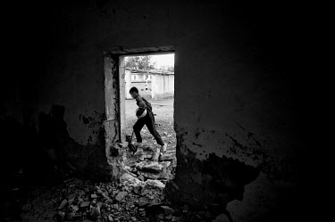 A boy runs past an abandoned building in Moynac. During the 1950s and the 1960s the rivers that feed the Aral Sea (the Amu Darya and the Syr Darya) were diverted for irrigating cotton and other crops....